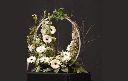 Arrangement of white flowers around a circular frame