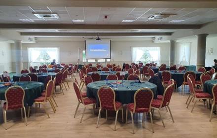 Summerson conference suite
Cabaret style tables with projector screen in the middle of the far wall