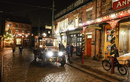 A Christmas evening at Beamish Museum with a vintage car and Christmas lights