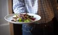 Waiter serving food at Lord Crewe Arms