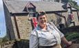 Image of a staff member in traditional clothing at the1940s Farm at Beamish Museum