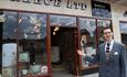 A staff member outside of 'A Reece Ltd, Radio and Electronics' store at Beamish Museum