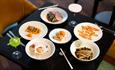 A table set out for a meal with various food options at Geko Japanese restaurant in Seaham Hall Serenity Spa