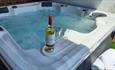 Wine and glasses by the Hot Tub at Oswin Lodge