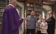 Image of a family speaking to a member of staff at Durham Cathedral Museum.
