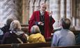 Image of a member of Durham Cathedral staff giving a tour to visitors.