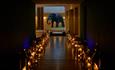 Elephant statue and walkway lit with candles