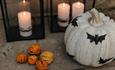 A decorated pumpkin and candles