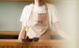 Chef serving a meal from the tasting menu with wine - Faru
