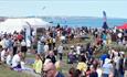 Crowds of people at Seaham Food Festival with north sea visible in the background.