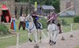 Men on horse back jousting