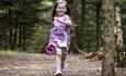 Child running through woodlands