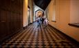 a family walking along a corridor of Ushaw Historic House