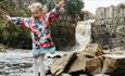 Child playing on rocks at High Force