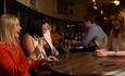 group of women laughing and drinking at Champagne Bar by Egony