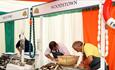 A scene from a previous festival. 3 members of staff preparing oysters on the counter at various stalls.