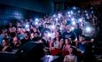 Audience using their phones as torches at Durham Fringe Festival.