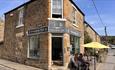 Diners sitting outside Serendipity Cafe on a sunny day in Lanchester.
