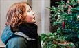 Child looking at a Christmas Tree outdoors