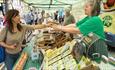 Trader at Barnard Castle Farmer's Market at stall taking money from customer