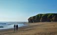 A couple walking on beach