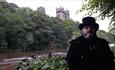 Andrew Ross (Tour guide) standing on the riverbanks at Durham with Durham Cathedral in the background