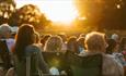 An audience watching outdoor cinema at Raby Castle