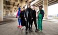 Group 'Diddy Sweg' posing in colourful  clothing, costumes and masks.