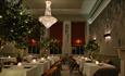 The Dining Room at Seaham Hall with tree decorations and lit candles on the tables