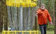 A man playing disc golf at Hamsterley Forest