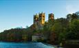 Durham Cathedral view from riverbank with river and woodland