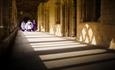 People walking along the cloisters