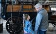 Man and girl looking at a locomotive