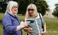 Visitors capturing photos on a mobile device at Raby Castle