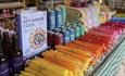 Farm Shop display of cookery books, and a selection of drinks and colourful items.