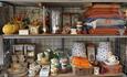 A display of Broom House Farm Shop gifts such as blankets candles and polkadot crockery.