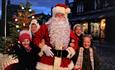Father Christmas at Beamish Museum with a group of children and Christmas Tree