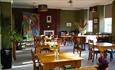 Francis Thompson Lounge & Bar. A colourful space decorated with tables, chairs and plants.