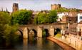 view of Durham City showing cathedral, castle, Elvet Bridge and surrounding buildings.