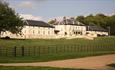 Exterior view of Hardwick Hall Hotel from Country Park on a sunny day.