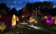 Camping pods lit up at night