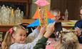 Children enjoying crafts activities, making colourful rockets