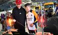 Two children participating in hands-on science experiments at Locomotion.