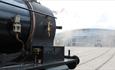 Steam train in front of the collections building at Locomotion