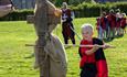 A child dressed in medieval clothing taking part in one of the activities