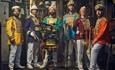 Group 'Mr Wilsons Second Liners' posing in colourful military style uniform