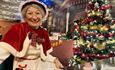 Mrs Claus sitting beside the Christmas Tree at Adventure Valley