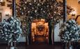 The Old Barn, St Cuthbert's Suite, a stunning setting for a traditional ceremony - floral decorations either side of the aisle.
