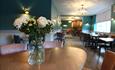 Restaurant table with a vase of white flowers