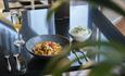 Bowl of curry and rice, glass of wine